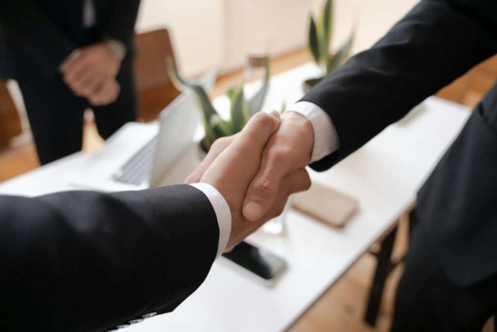 Business executives networking shaking hands