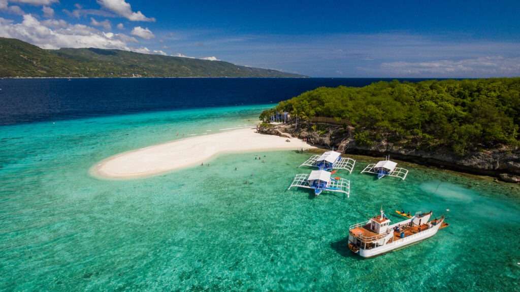 An aerial perspective of the Sumilon island beach landing near Oslob, Cebu, Philippines