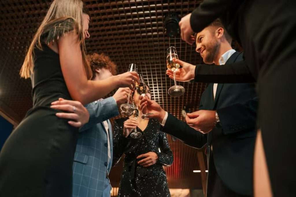 Group of people in elegant clothes celebrating indoors together